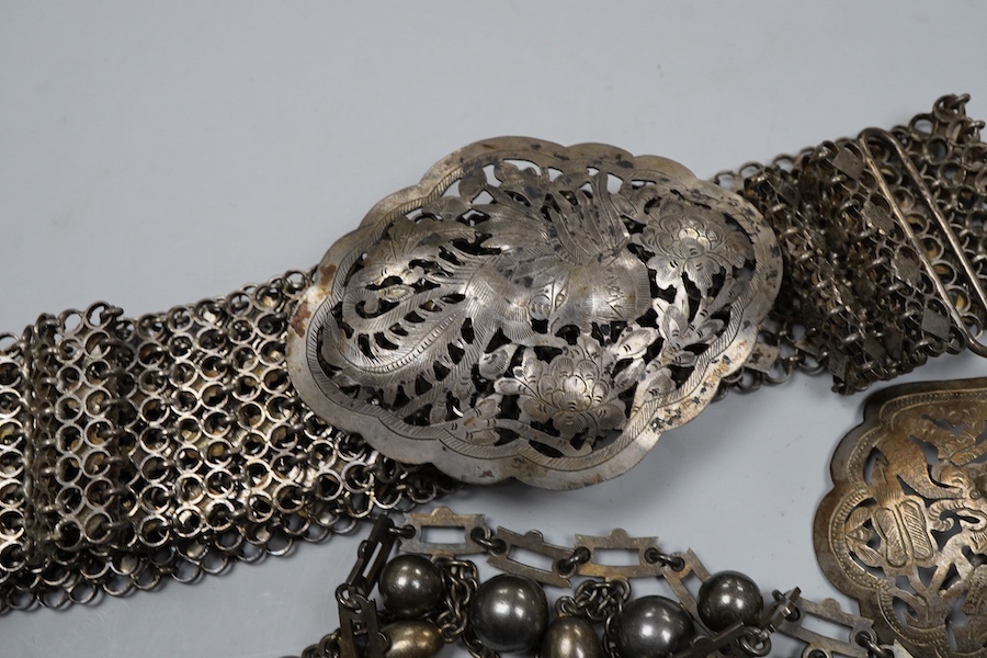 A collection of accessories and a silver spoon, comprising: a Victorian necklace, second half 19th century, composed of a series of links suspending graduated chain festoons and spherical and oval links with pointed pend